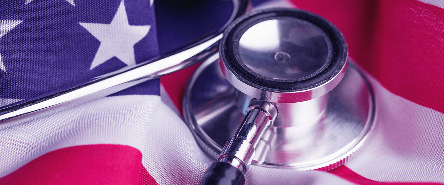 Close-up of a stethoscope on an American flag, symbolizing healthcare in the U.S.