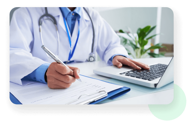 Physician Writing with Laptop