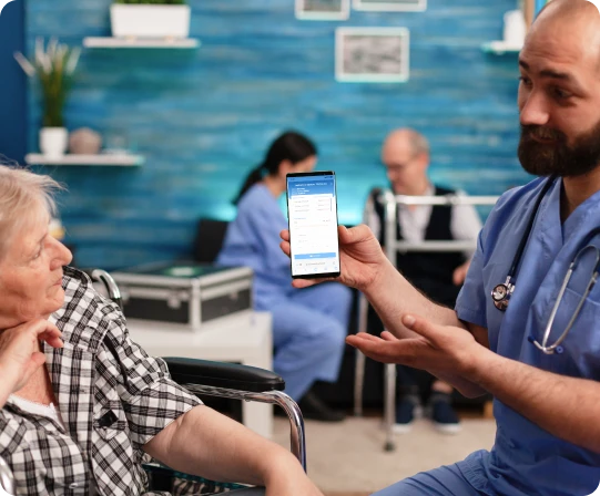 Doctor showing CareCloud app to patient.